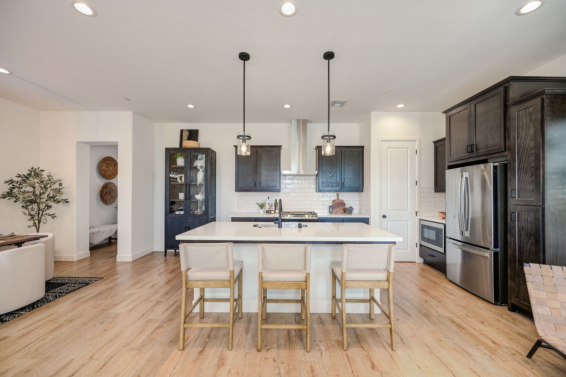 Sleek and stylish modern kitchen featuring a central island, pendant lights, and stainless steel appliances in Scottsdale, AZ