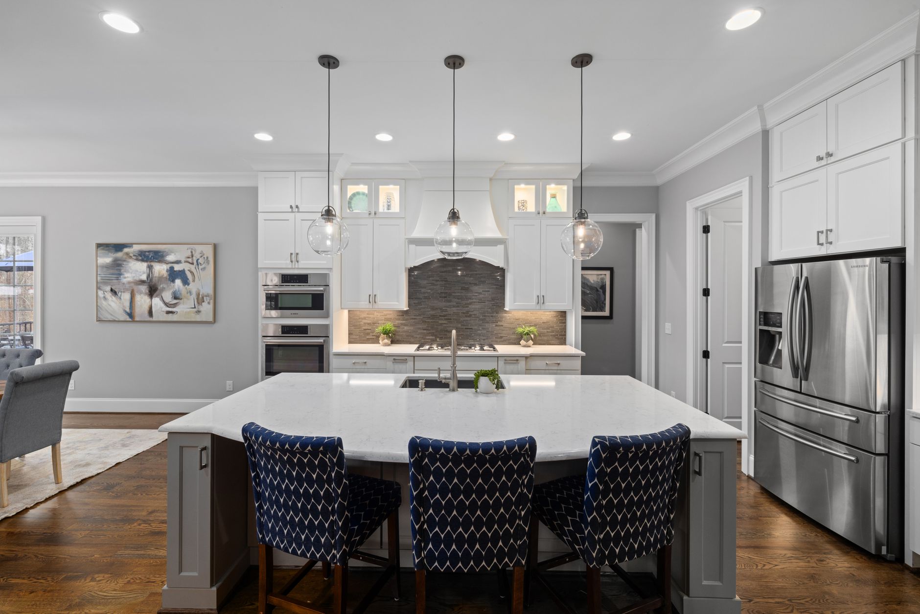 Bright modern kitchen featuring white cabinets, island, and stainless steel appliances in Scottsdale, AZ
